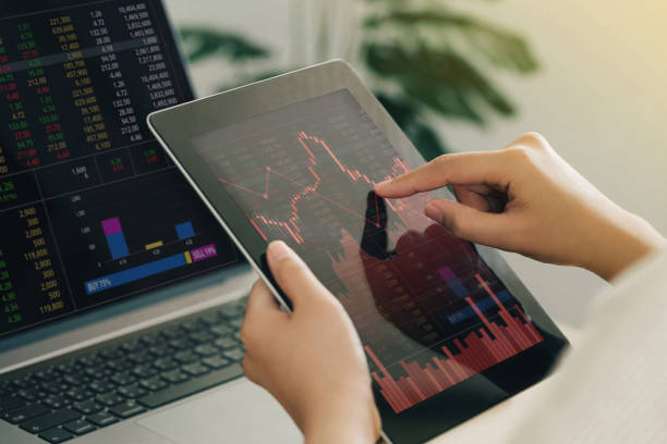 istock Businesswoman using a tablet computer analyzing stock exchange market crypto trading decreasing chart data fall down loss, desperate about losing money of crisis, recession, inflation.Economic crisis 1425118031