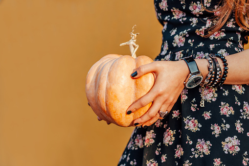 Closeup of girl holding a pumpkin
