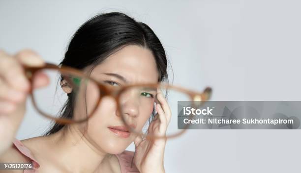 Asian Beautiful Woman Is Looking To Her Glasses With Problem Of Her Eye Stock Photo - Download Image Now