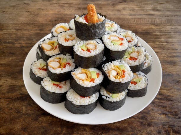 Homemade chicken katsu maki sushi stacked in 3 tiers on a plate