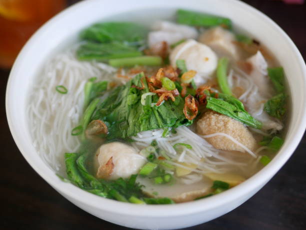 Selective focus seafood vermicelli in a bowl and served on the table. Vermicelli soup with seafood is the right menu to serve when the air is cold, gathering with family. stock photo
