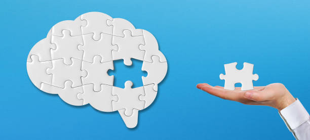 istock Hand holding a missing piece of the brain puzzle. Mental health and problems with memory. 1425127163