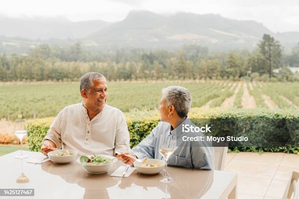 Senior Couple Love And Dinner At Outdoor Restaurant Diner Or In Nature While Having A Conversation Romance Retirement And Elderly Man And Woman Eating Together At A Table In Communication Stock Photo - Download Image Now