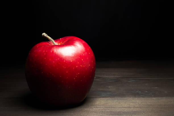 Red apple on black background. Concept of freshness. Horizontal view. Copy space