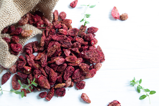 Dried strawberries on a white background with a place for text.