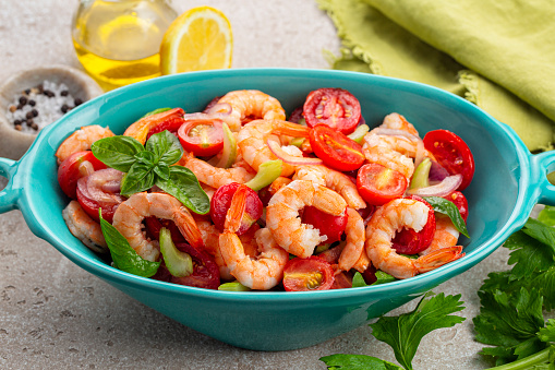 Seafood mediterranean salad with vegetables. Catalan prawns or shrimps, made with tomatoes, red onion, celery, basil leaves with olive oil and orange juice.