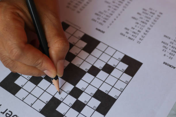 pencil and solves crossword puzzle Pencil and glasses on the paper with solved number crossword puzzle crossword stock pictures, royalty-free photos & images