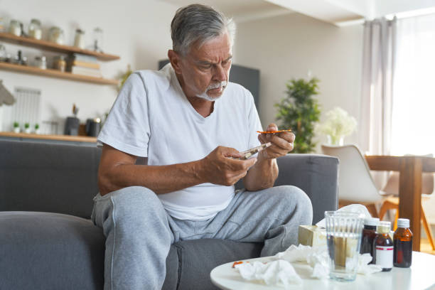 istock Senior caucasian choosing pills during the flu 1425133076