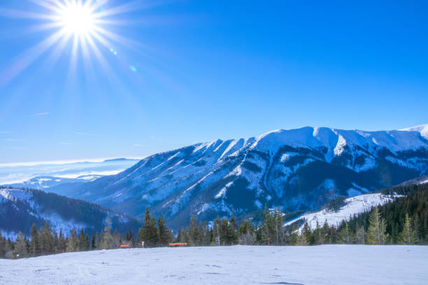 Photo of Sun Over Empty Ski Slope and Mountain Relief