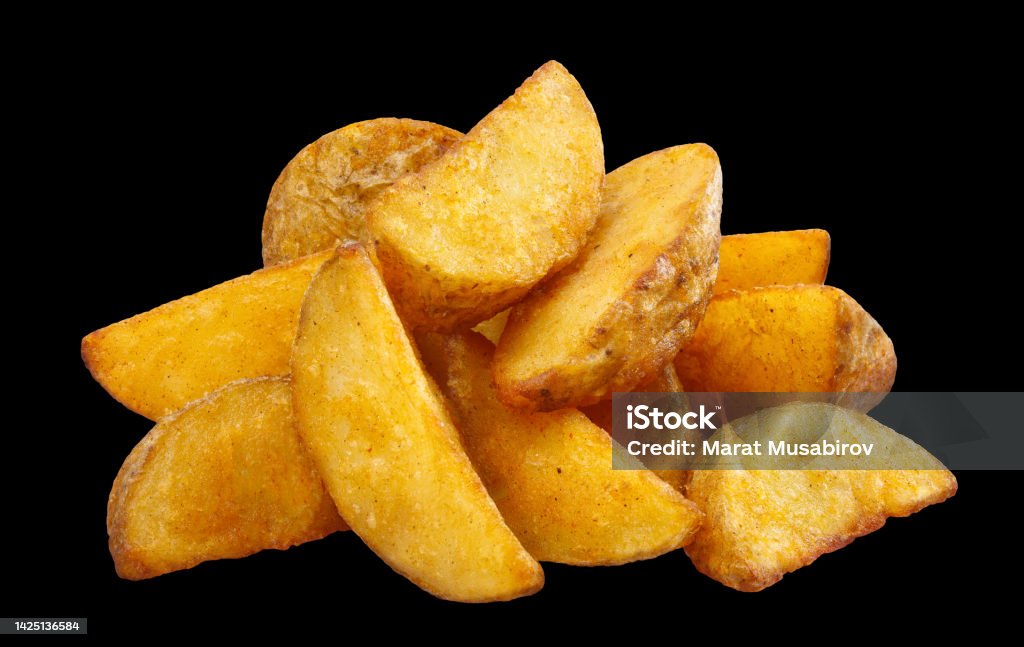 Delicious fried potato wedges on black Delicious fried potato wedges, isolated on black background Baked Stock Photo