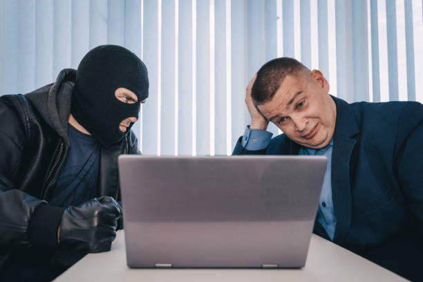 extortionist thief demands money in the businessman's office. theft of personal data and information. bank robbery. the concept of extortion and robbery. - extortionist imagens e fotografias de stock