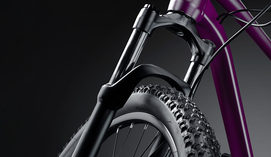Front part of a new mountain bike close up on a black background. Studio shot. Professional sport equipment.