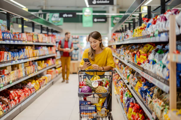 istock Purchasing Goods with Smartphone at Grocery Store 1425138318