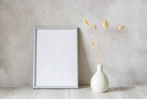 istock Template with photo frame on a wooden table. Bouquet Lagurus. Sunlight from the window. 1425140701