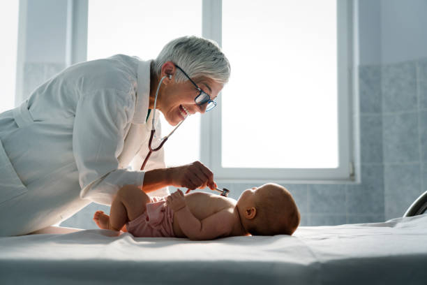 Pediatrician examining little baby to prevent diseases stock photo