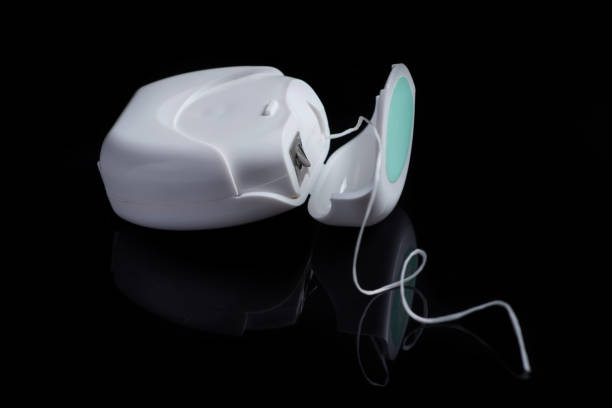 istock Container with dental floss. Floss on black background. White dental floss case isolated. Open dental floss container 1425142421