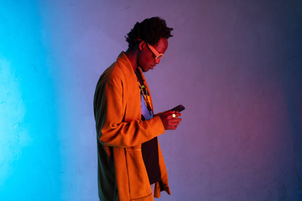 istock African man staring at smart phone 1425145569