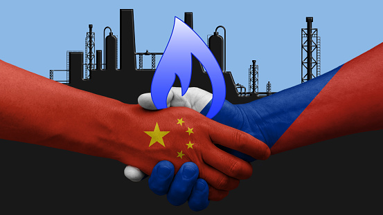 China and Russia gas sale agreement. Hands shake with state flags. In the background a gas factory drawing
