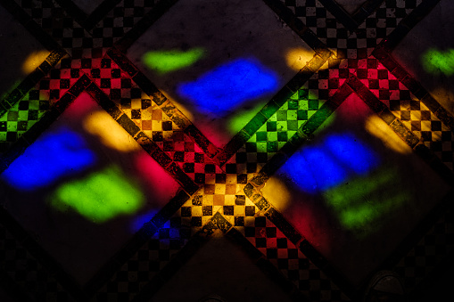 Colourful stained glass lighting an Arabian tiled style wall in Marrakesh