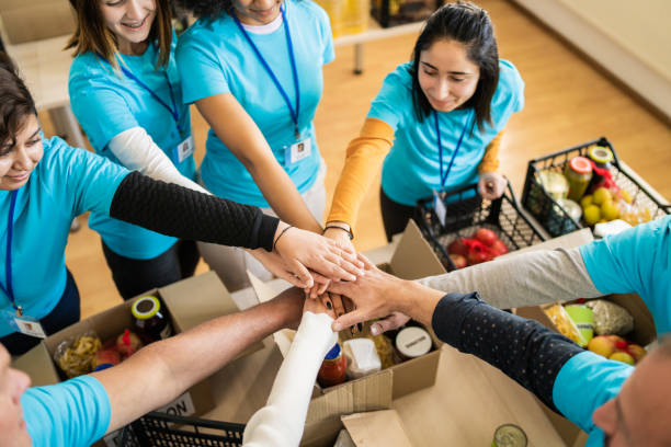 istock A circle of volunteers stacking their hands in a circle 1425147076