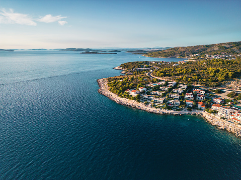 Luxury apartment villas on the coast of Croatia by the Adriatic sea. Ocean view, front row to the beaches, aerial view at sunset with private swimming pools.