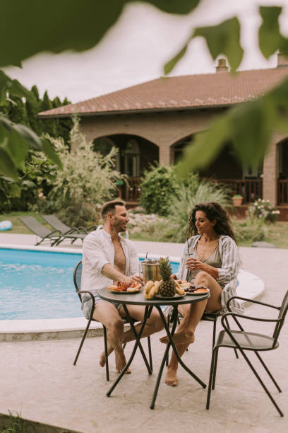 istock Young couple sitting in the backyard 1425147319