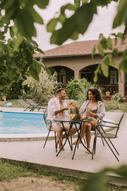 istock Young couple sitting in the backyard 1425147321