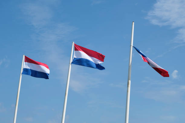 istock Three red white blue dutch flags on flagpoles in strong wind 1425147354