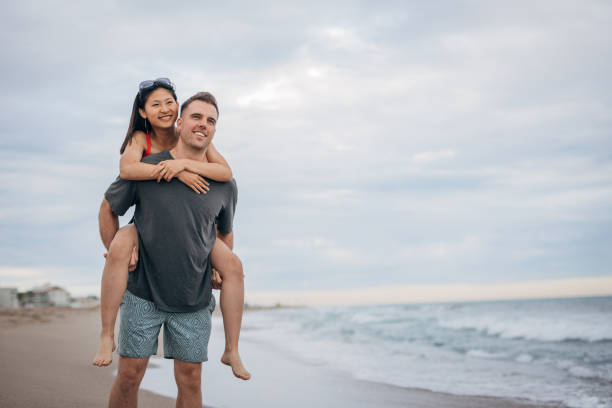 istock Multi ethnic couple man holds on hands beautiful woman 1425148545