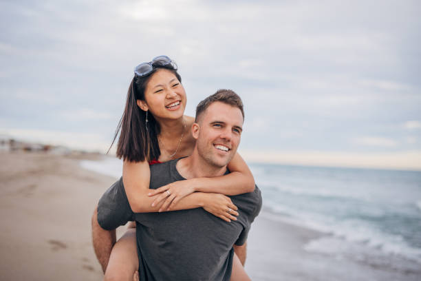 istock Multi ethnic couple man holds on hands beautiful woman 1425149456
