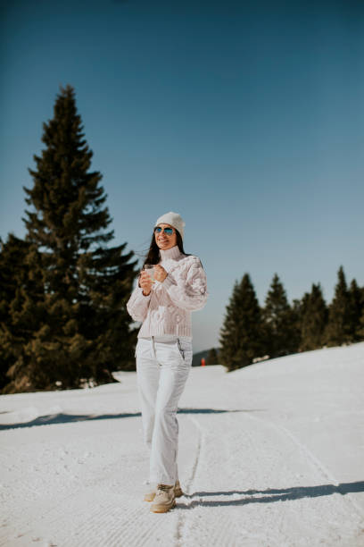 istock Young woman drinking lemonade  on the mountain ski track 1425151802