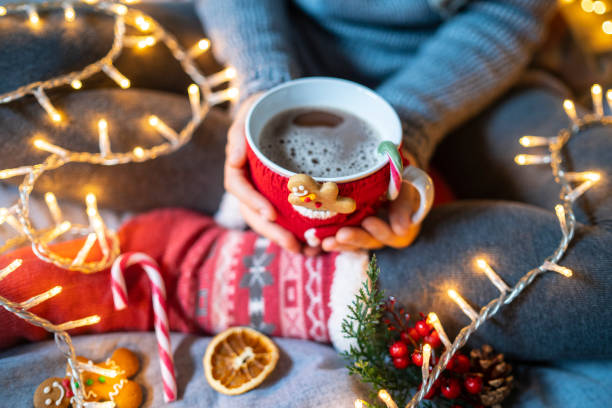 istock Hands cupping a hot beverage with a candy cane on the side 1425156556