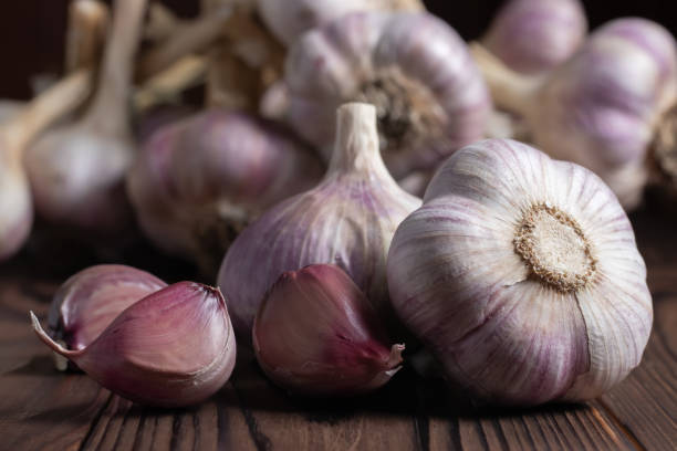 istock Garlic bulb on wooden background. Close up 1425158061