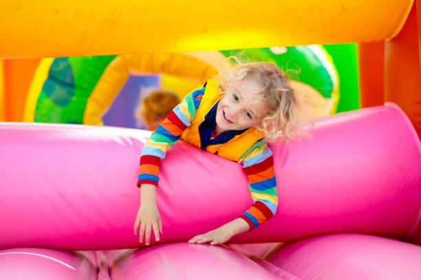 istock Child jumping on colorful playground trampoline 1425159861