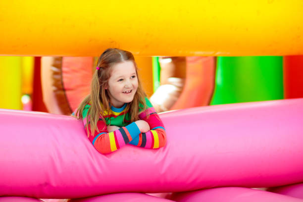 istock Child jumping on colorful playground trampoline 1425161389