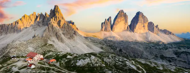 Photo of Stunning panoramic view of the Three Peaks of Lavaredo (Tre cime di Lavaredo) during a beautiful sunset. The Three Peaks of Lavaredo are the undisputed symbol of the Dolomites, Italy.