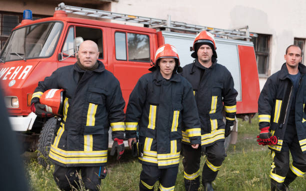 istock Group of fire fighters standing confident after a well done rescue operation. Firemen ready for emergency service. 1425161732