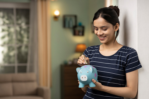 Woman saving money in a piggybank