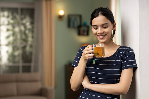 Young woman drinking green tea