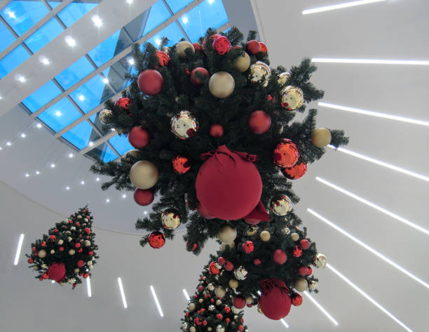Christmas trees hanging from the ceiling as creative decoration, low angle view from bellow
