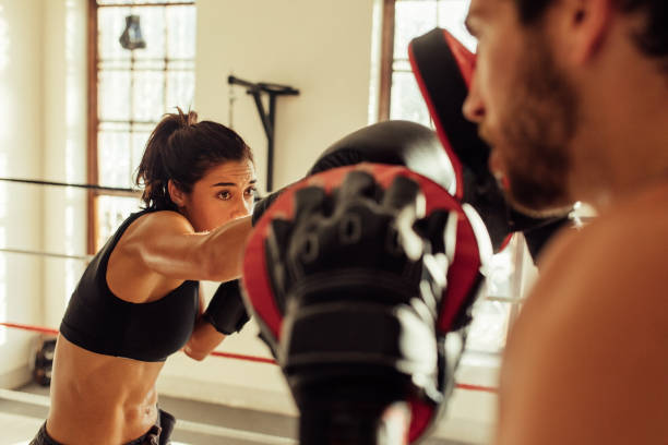 istock Beautiful young female pugilist throws a punch 1425166253