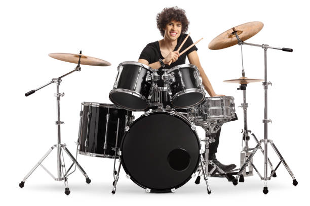 istock Smiling young male drummer holding drumsticks and sitting with a drum set 1425167255