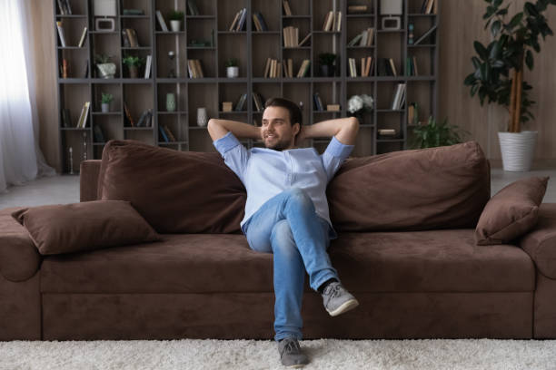 istock Happy carefree young man resting in cozy couch. 1425167344