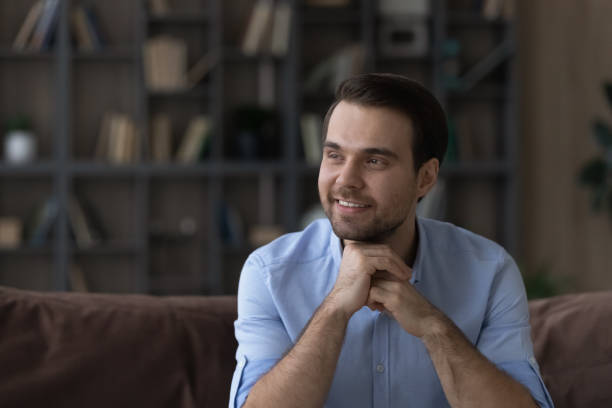 istock Dreamy young happy handsome man looking in distance. 1425167368