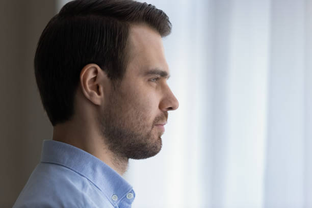 istock Dreamy confident young man looking in distance. 1425167378