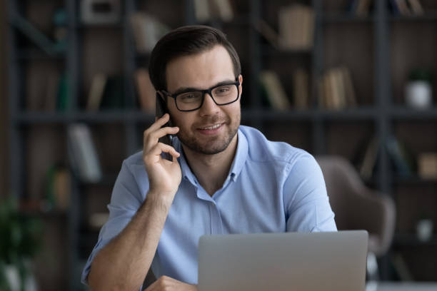 istock Happy friendly young business man multitasking at home. 1425167385