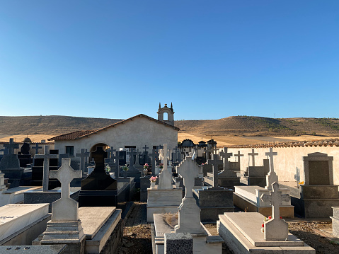 Rural cemetery with graves and religious symbols