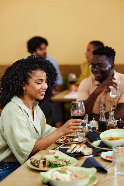 istock A smiling Hispanic girl is having dinner in a restaurant. 1425170442