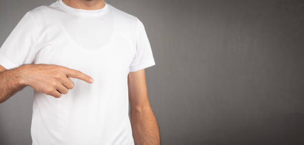 istock Man in a white t-shirt at grey background. 1425171977