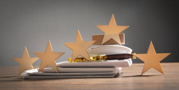 istock Wooden 5 stars with a business objects on the table. Increase rating 1425171981
